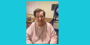image of woman with short brown hair and pink sweatshirt smiling