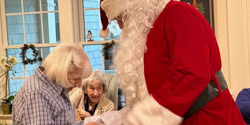 Santa and residents at holiday party